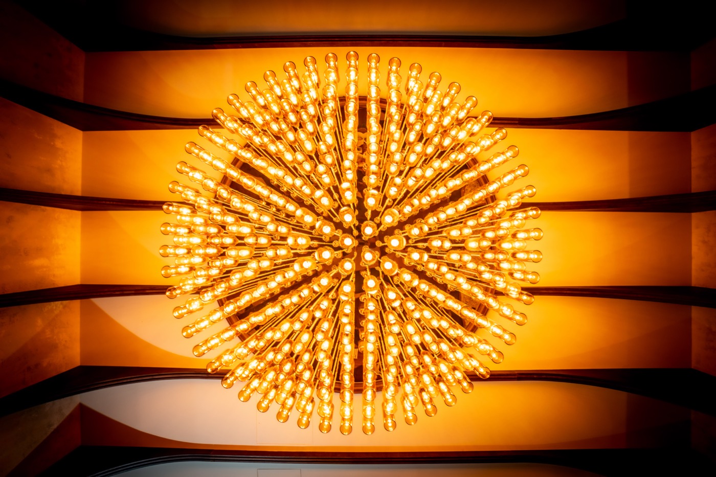 The Velvet Club under the golden radial chandelier