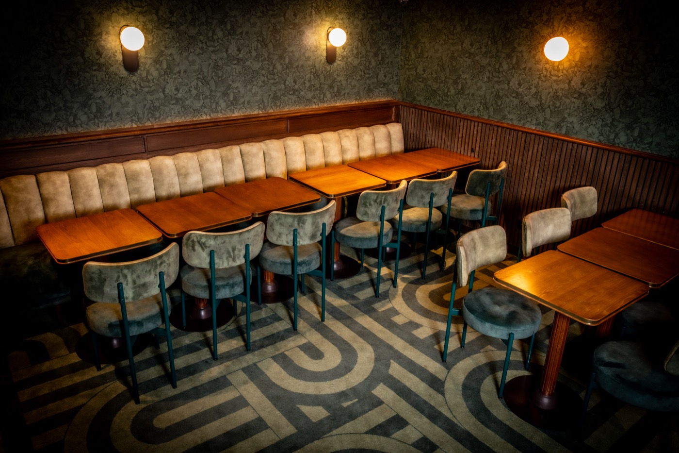 The private room at Les Causeurs, cream banquettes and a labyrinth-patterned floor