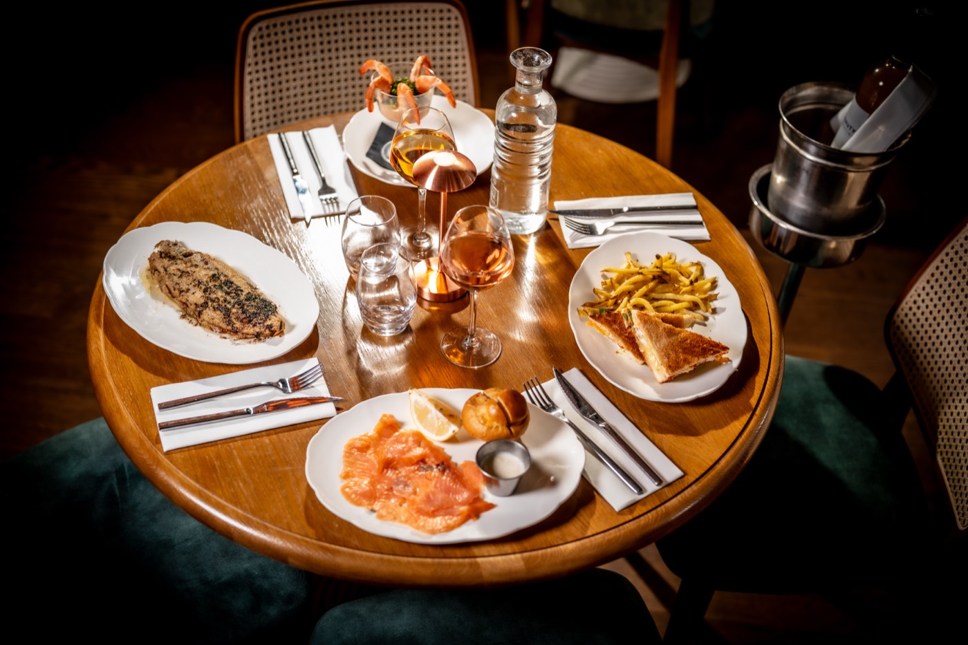 A table laid at Les Causeurs, dishes to share and house matchstick fries